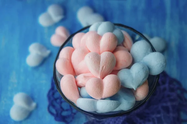 pink and blue meringue hearts on painted purple background, tasty love, Valentines Day