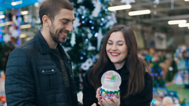 夫妇与雪花玻璃球在商店 — 图库视频影像