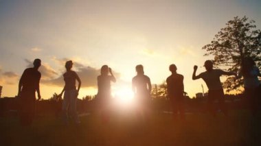 Mutlu arkadaş günbatımında atlama