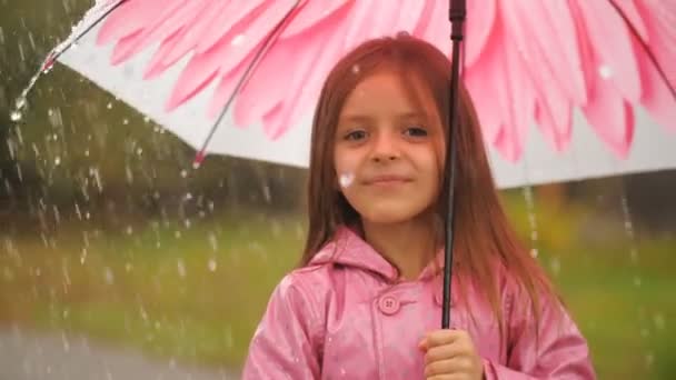 Niña con paraguas bajo la lluvia — Vídeo de stock