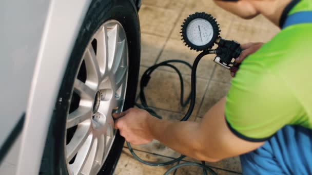 Mécanicien automatique vérifiant la pression des pneus — Video