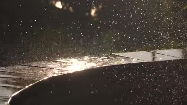 Waterdrops from fountain on sunset — Stock Video