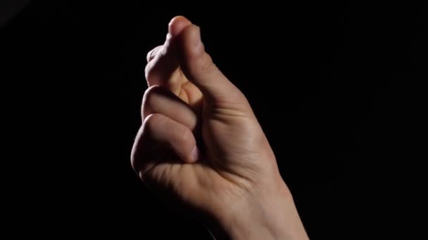 Mans hand snap finger on black background — Stock Video