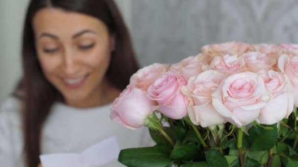 Woman reads a message taken from flowers — Stock Video