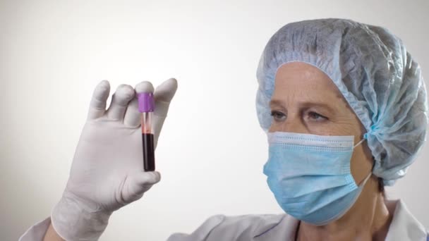Medico esaminare tubo con sangue — Video Stock