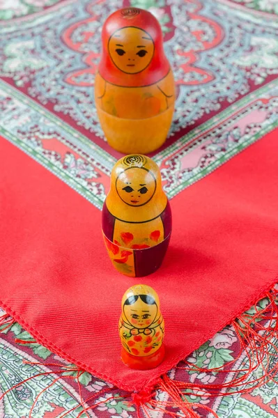 Russian nesting dolls on the traditional handkerchief.