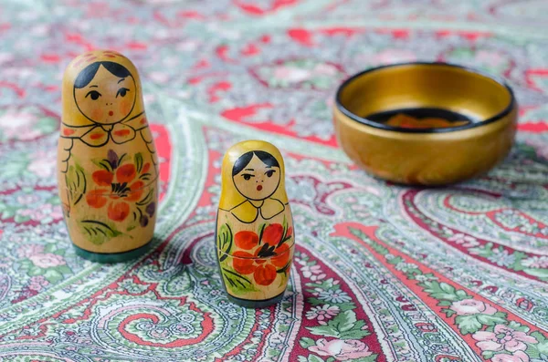 Russian nesting dolls on the traditional handkerchief.