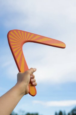 Boomerang in front of a blue sky clipart