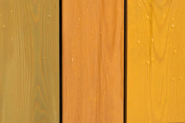 Dřevěný plot vzor mokré barvy žluté, zelené a oranžové — Stock fotografie