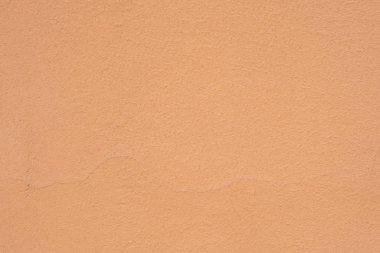 Arka plan bej çimento duvarın sıva kaba tarzıdır.