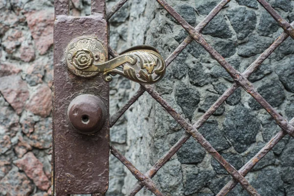 ancient antique bronze door with iron chain knob.