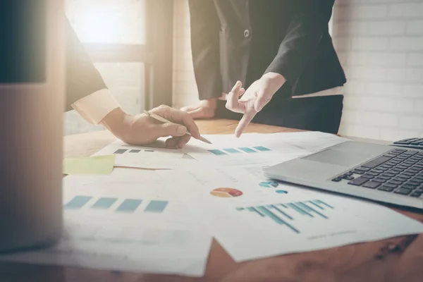 Close-up of female and male hands pointing at turnover graph whi — Stock Photo, Image