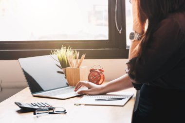 Kadın muhasebeci hesap makinesi ve dizüstü bilgisayar kullanıyor.. 