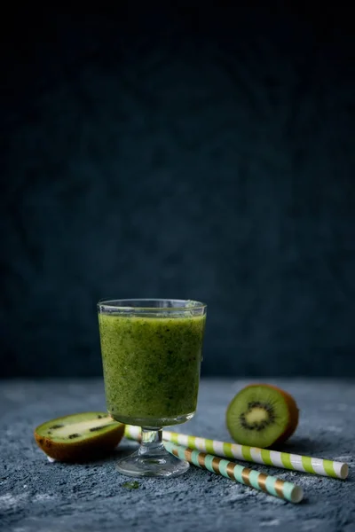 Natural green smoothie. Useful and healthy breakfast, brunch or having a snack. Smoothie in a jar from spinach, a kiwi and banana.