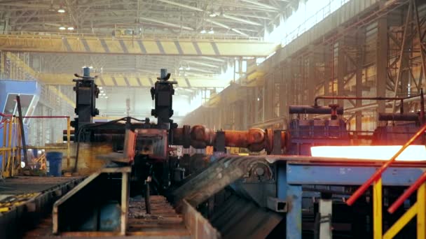 Ironworks plant. Working Machines moves burning hot billet — Stock Video