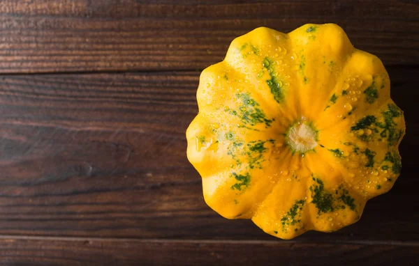 Yellow squash on a wooden background. Top view, Colorful festive still life. Copyspace.