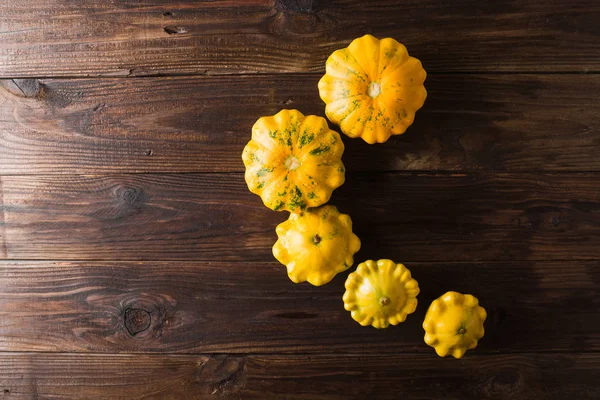 Yellow squash on a wooden background. Top view, Colorful festive still life. Copyspace.