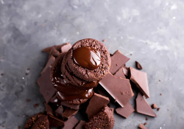 Chocolate cookies with melted chocolate and a slide of chocolate