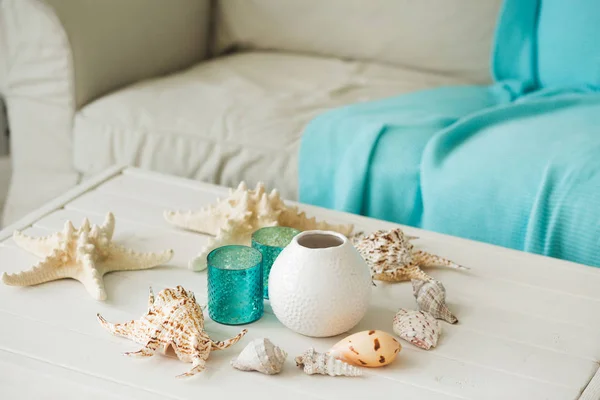 Marine Interior. White sofa and table, seashells