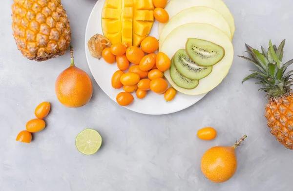 Pineapple, mango, kumquat, melon and kiwi — Stock Photo, Image