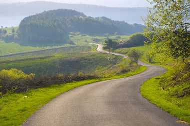 ülkede yol yeşil tepelerin üzerinden