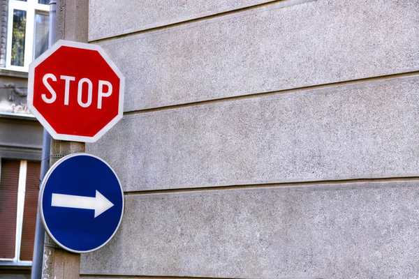 Red sign stop and blue sign arrow