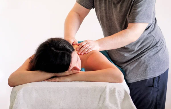 Relaxed woman with hand massage at beauty spa center