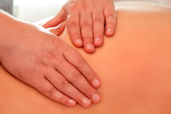 Close up detail of hands massaging female shoulder and back — Stock Photo, Image