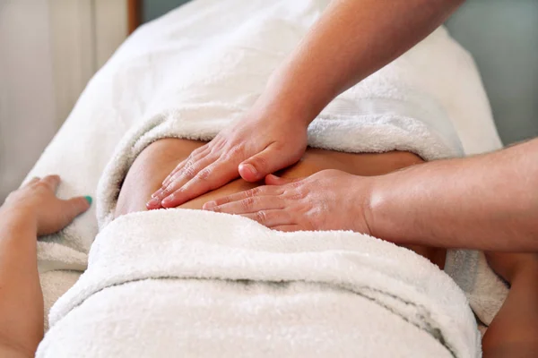 Masseur massaging girls belly — Stock Photo, Image