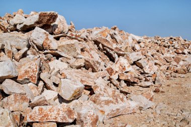 Kahverengi granit. Kaya inşaat ve bir yığın yaz aylarında mavi gökyüzü altında kazıklı kayalar büyük yığını. Kireç ocağında büyük bir yığın. Çakıl ve inşaat malzeme yığını.