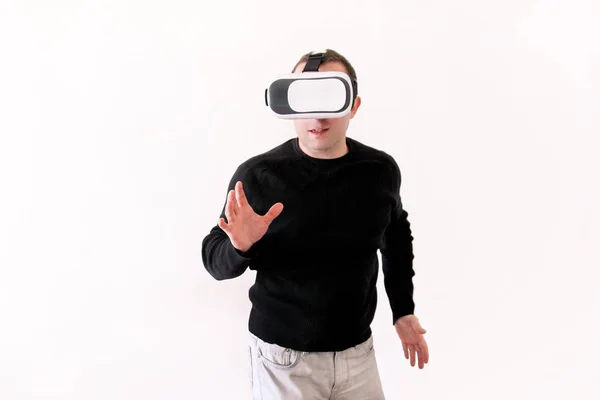 Man wearing and playing mobile game app on device virtual reality glasses on white background. Business man at office action and using in virtual headset box. Contemporary technology concept. — Stock Photo, Image