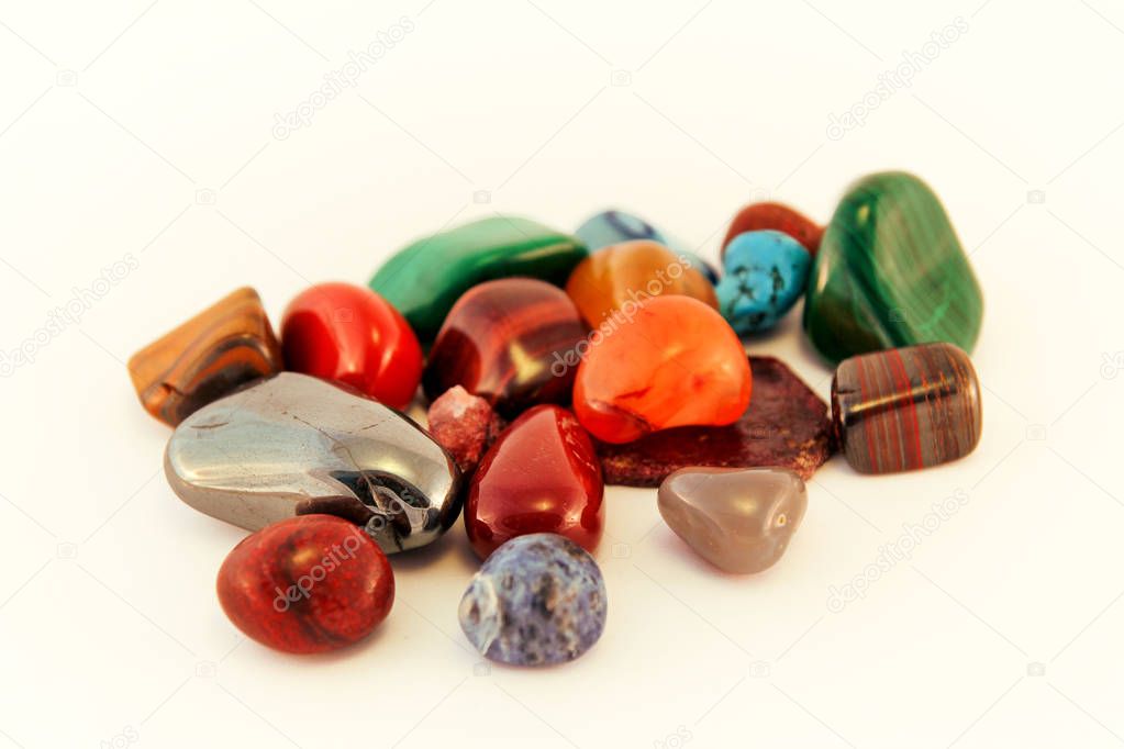 Semi precious stones / Crystal Stone Types / healing stones, worry stones, palm stones, ponder stones / Various stones gemstones background texture / Heap of various colored gems mineral collection.