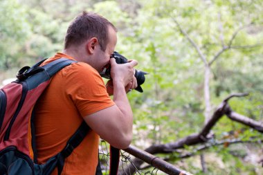 Ormandaki profesyonel erkek fotoğrafçı / çocuklar güzel bir gün zevk turist doğa fotoğraf orman doğal ortamında,. Adam fotoğrafçı doğa fotoğraf çekimi. Seyahat, macera kavramı.