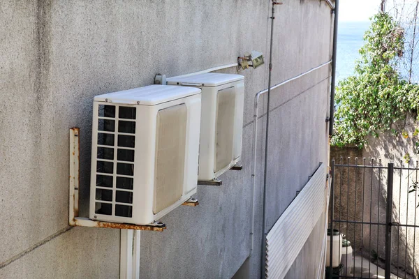 Air conditioning system assembled on a wall of building / Outdoor climate unit and cooling and heating systems.