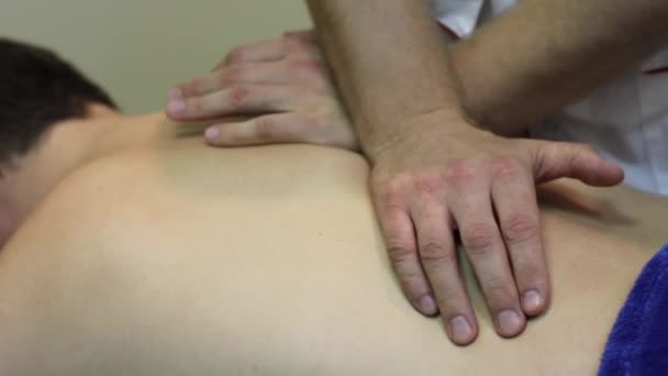 Mãos masculinas fazendo uma massagem nas costas — Vídeo de Stock