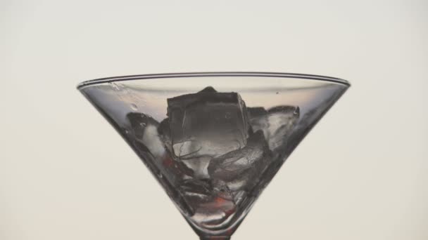 Cooking martini glass with ice and olives. — Stock Video