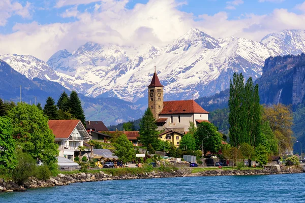 Brienz town near Interlaken and snow covered Alps mountains, Swi