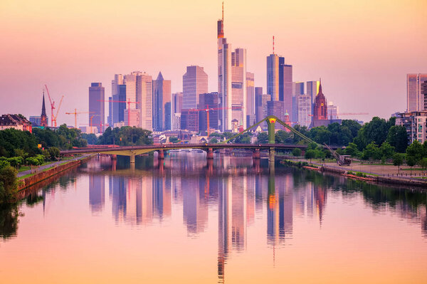 Frankfurt financial district skyscrapers reflecting in Main river, Germany, on sunset