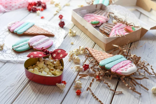 A bright pin up style photo with cookies in shape of ice-cream cones, macarons and cupcakes