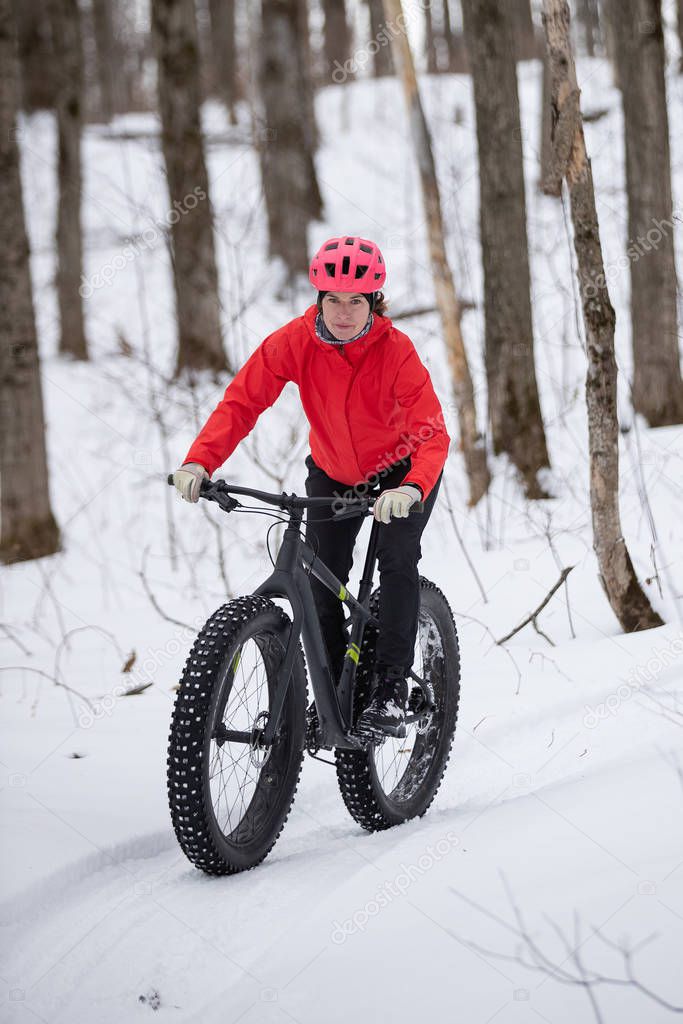Woman riding her fat bike in the snow in Ontario, Canada