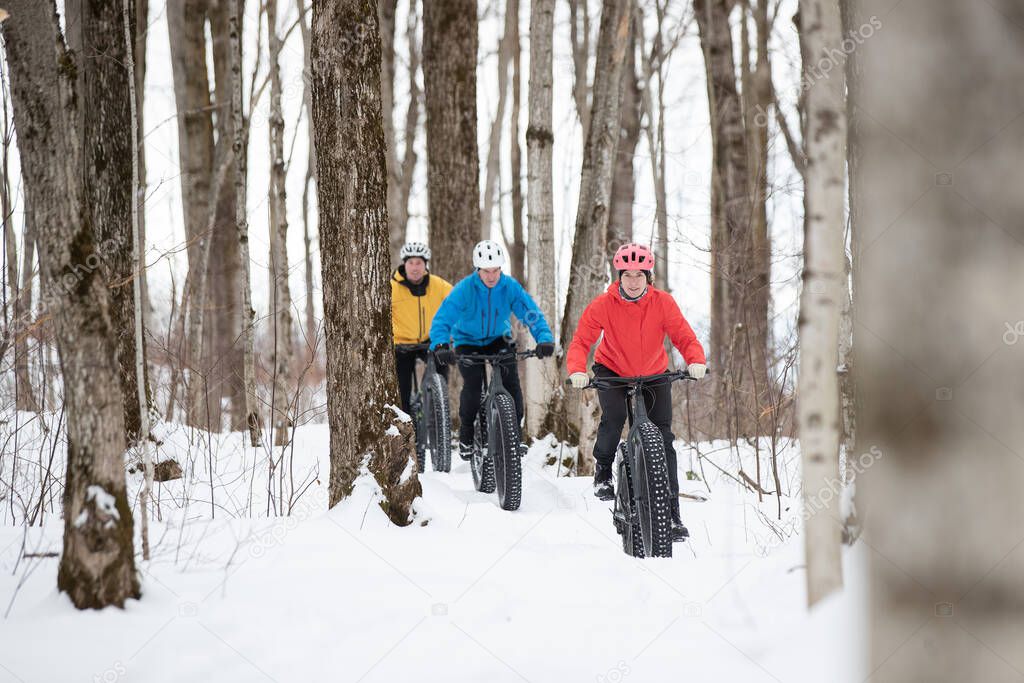 Group of friends riding their fat bike in the snow in Ontario, Canada