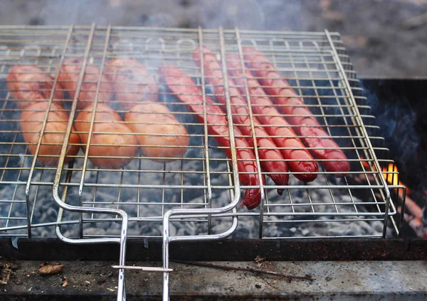 Grilled sausages on the smoke. — Stock Photo, Image