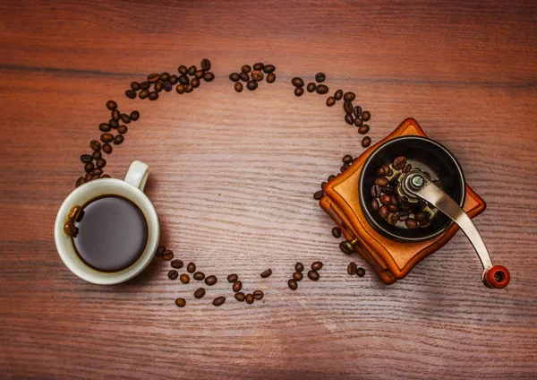 Una tazza di caffè con un macinino da caffè su un albero — Foto Stock