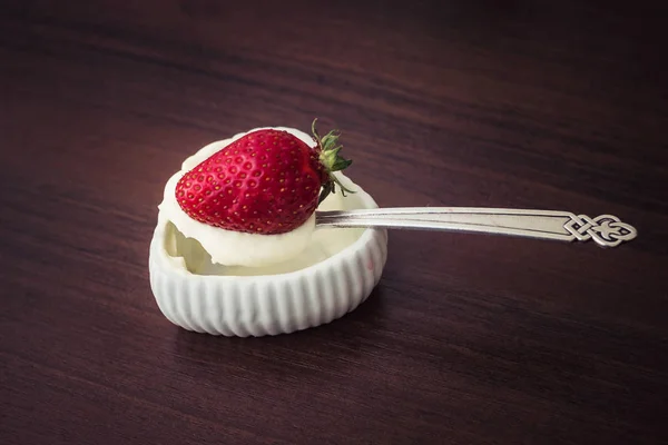 Strawberry on a small spoon with cream — Stock Photo, Image