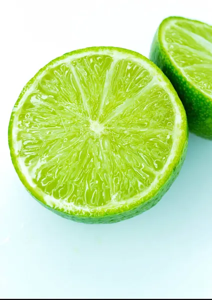 Sliced ripe juicy lime close-up on white — Stock Photo, Image