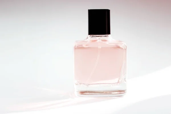 Glass bottle of perfume on a light background — Stock Photo, Image