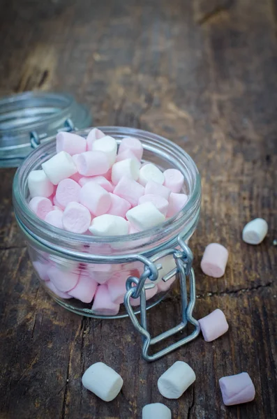 Pink and white marshmallows in a jar