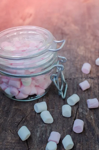 Pink and white marshmallows in a jar