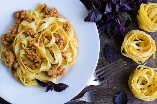 Pasta with bolognese sauce on wooden background — Stock Photo, Image