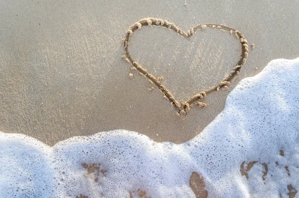 Heart drawn on a sand of beach Royalty Free Stock Photos